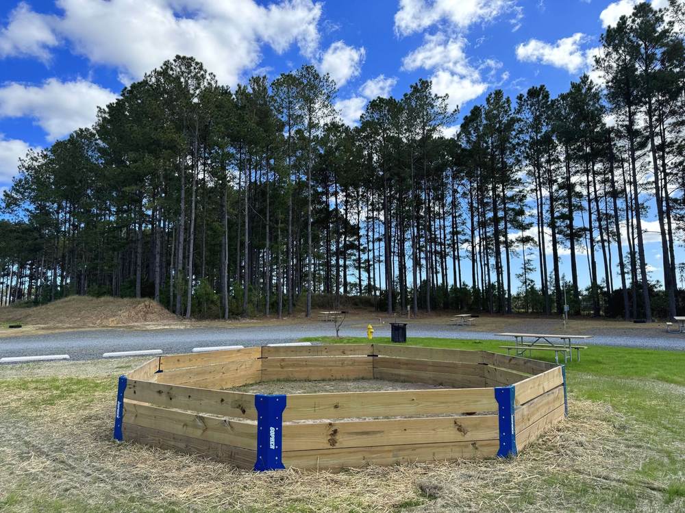 The wooden gaga ball pit on the campground lawn