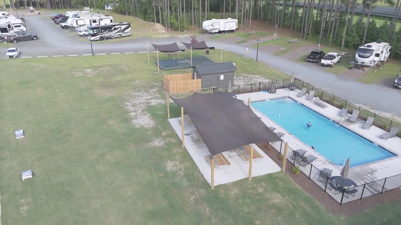 Aerial view of the pool, shade pavilion and the RV sites beyond